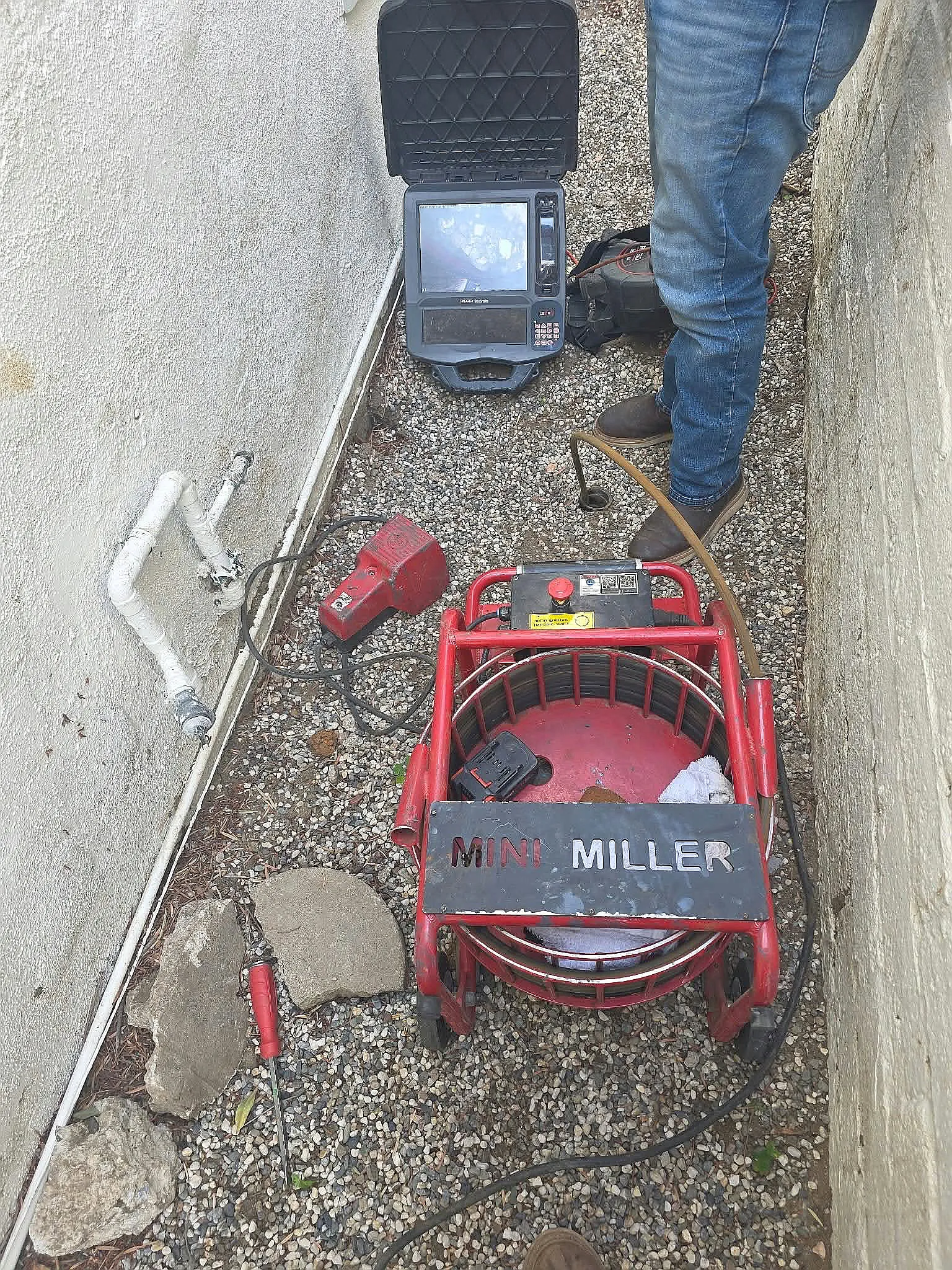 Drain cleaning machine and camera set up in a side yard