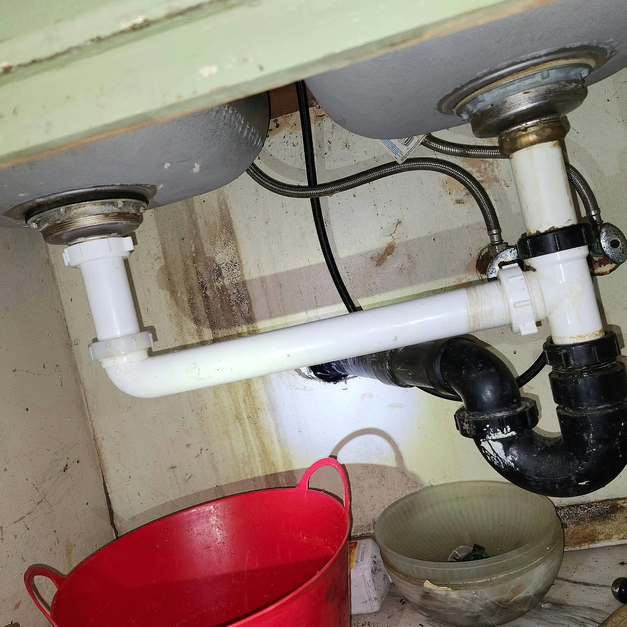 Kitchen sink drain and P-trap being cleared