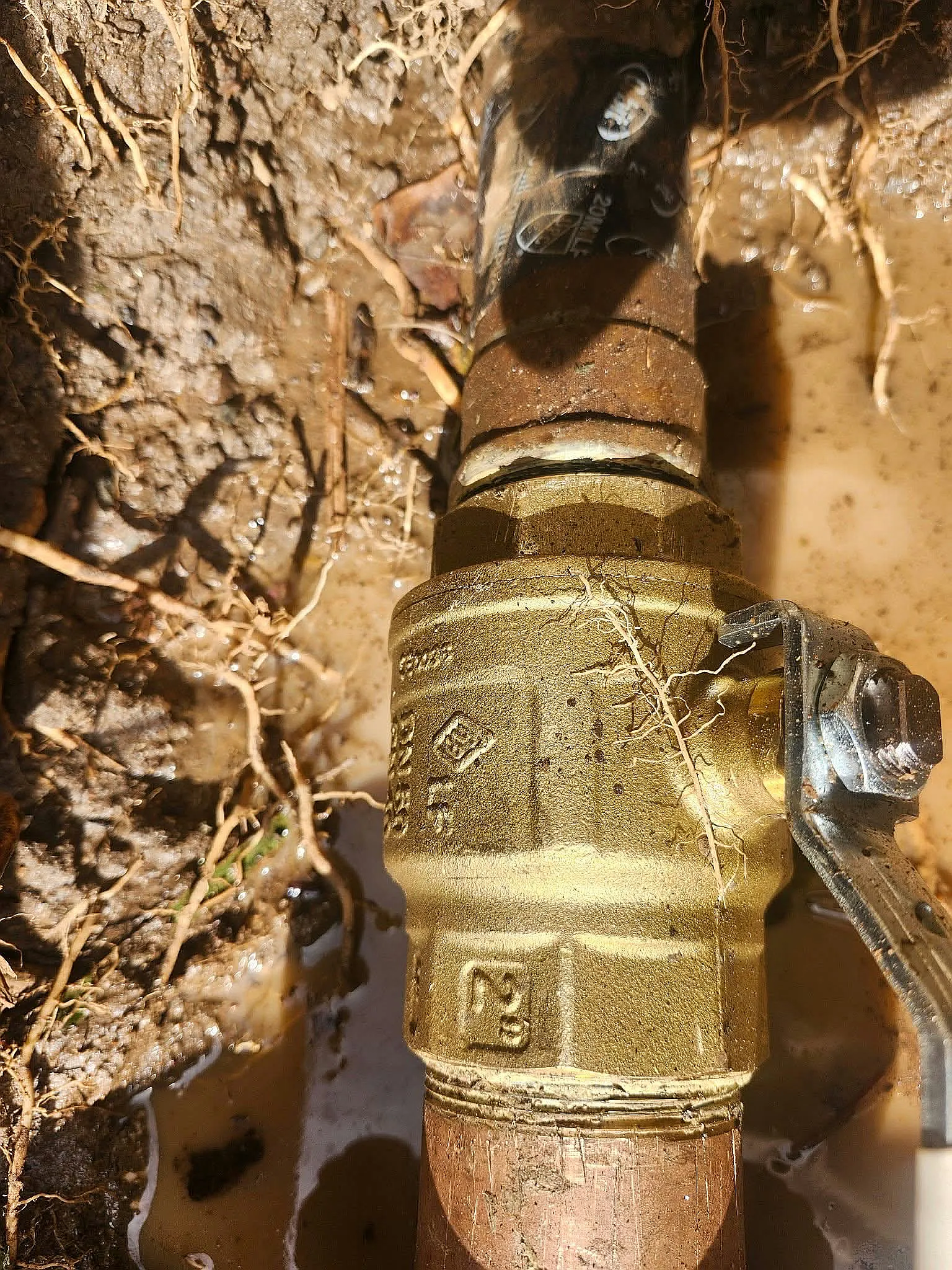New brass main shutoff valve on a water line