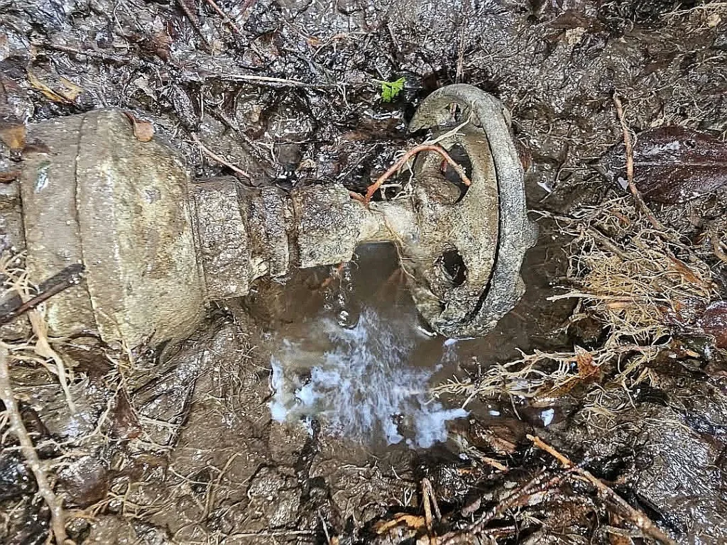Water spraying from a corroded underground valve