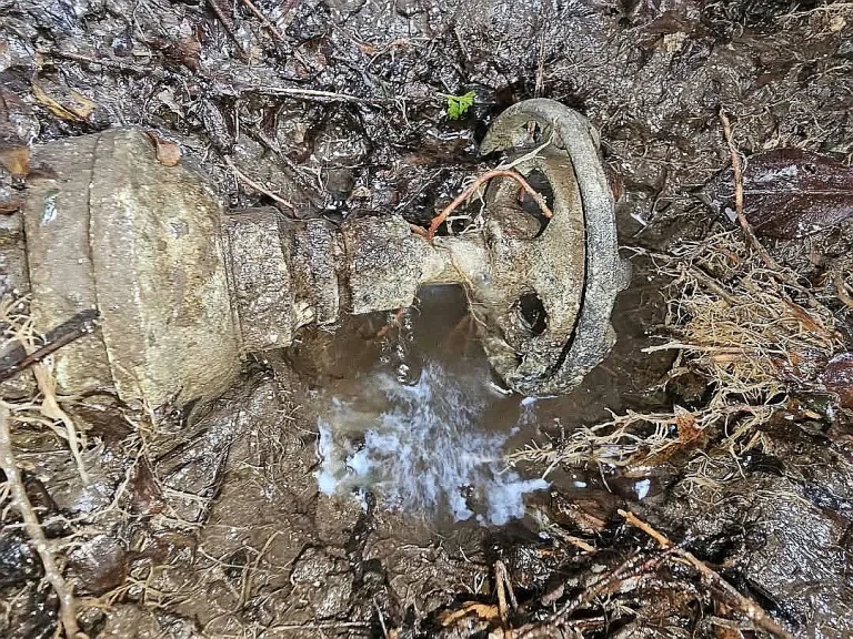 Water spraying from a corroded underground valve