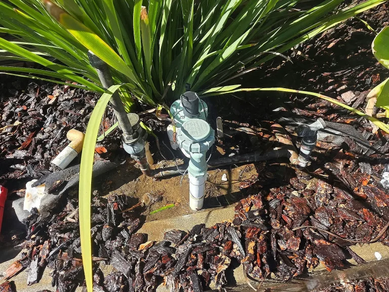 Irrigation valves in a planted garden bed