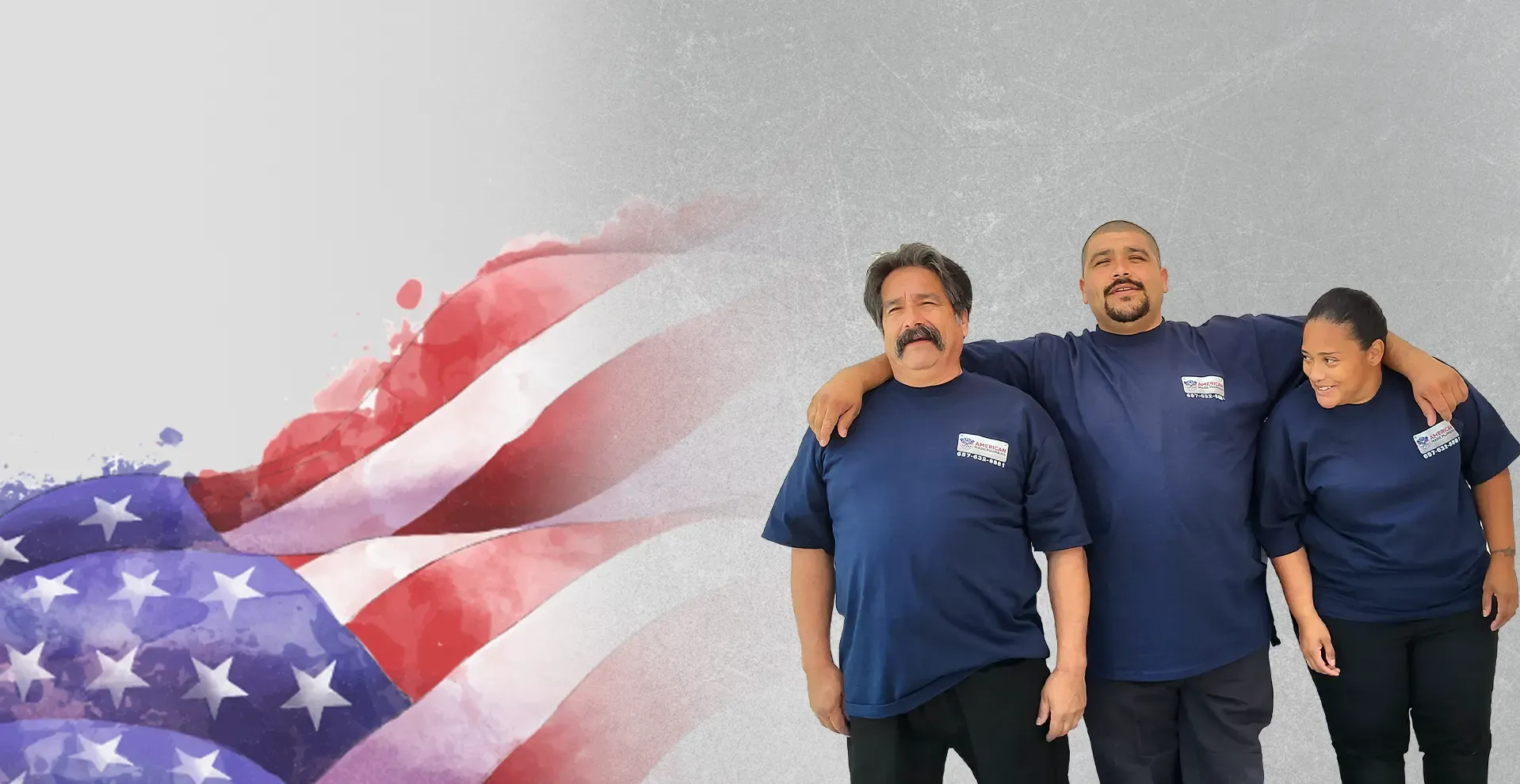 Three American Made Plumbing team members in company shirts beside an American flag